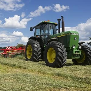 John Deere 4455 tractor and double turner, turning cut grass for silage, Tierp, Sweden, june