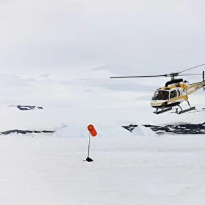 Tourists in helicopter, landing on snow, Devil Island, Weddell Sea, Antarctica, December