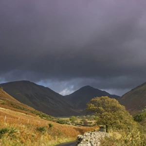 View of drystone wall at roadside in upland valley, with Red Pike Peak in background, Wasdale, Lake District N. P