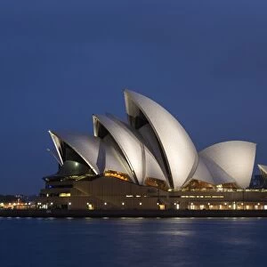 View of performing arts centre illuminated at night, Sydney Opera House, Sydney Harbour, Sydney, New South Wales