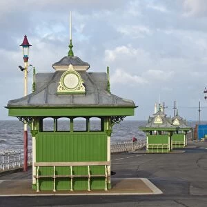 Wind shelters beside sea in seaside resort town, Blackpool, Lancashire, England, january