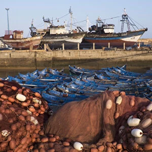 Africa, Morocco. Fish nets, floats, boats, and commercial fishing vessels of the