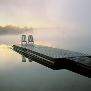 Canada, Ontario, Algonquin Provincial Park, Chairs on dock. Credit as: Nancy Rotenberg