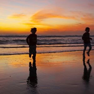 Children Playing on Beach at Sunset, Greymouth, West Coast, South Island, New Zealand