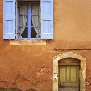 France, Provence, Roussillon. Weathered window and door of house