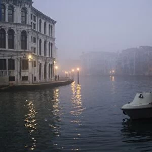 Italy, Venice. Boat moored on Grand Canal in early morning fog