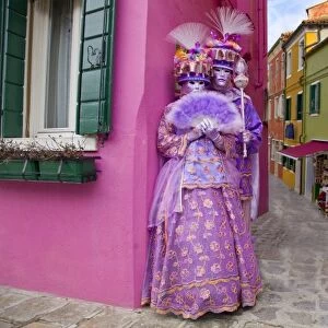 Italy, Venice. Couple dressed in costumes for the annual Carnival festival