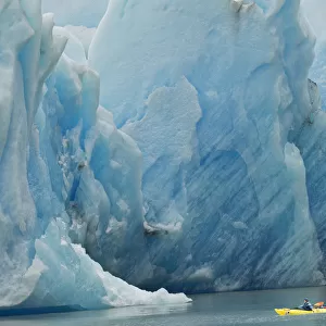 Kayakers exploring Grey Lake in front of massive Grey Glacier, Torres del Paine National Park
