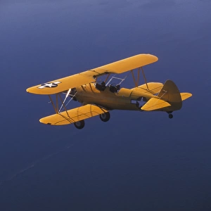 P. R. Yellow Biplane, 1944 Stearman PT-17, flying over Puget Sound, WA