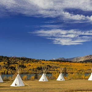 Tipis with Yellow Mountain in background at Chewing Black Bones campground near St Mary
