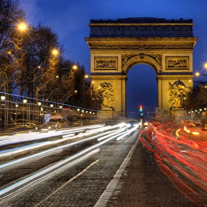 Traffic passes the Arch de Triumph on the Champs Elysee in Paris, France