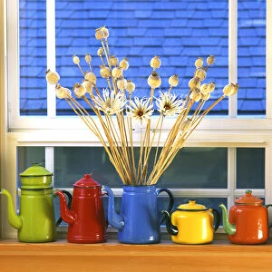 USA, Oregon, Portland. Enamelware teapots & coffeepots on window sill. Credit as