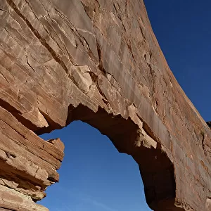 USA, Utah. Jeep Arch and clouds near Moab