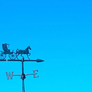 weathervane atop barn indicates wind direction. weathervane, weather, horse