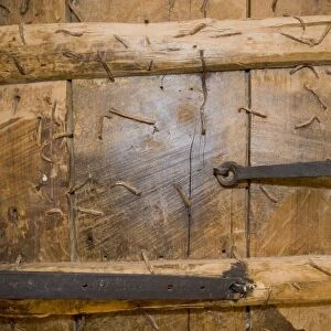 Detail of wooden church door full of nails, Mardin, Turkey