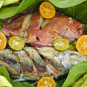 Yap. Local cooked fish in woven food baskets