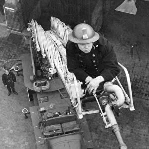 Blitz in London -- AFS firefighter on ladder, WW2