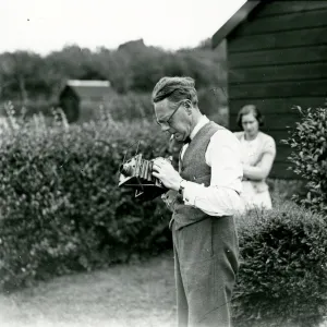 George Garland in a garden with his camera, September 1938