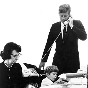 35th President of the United States. Photographed with his secretary, Evelyn Lincoln, and with his son, John F. Kennedy, Jr. in the Presidents office