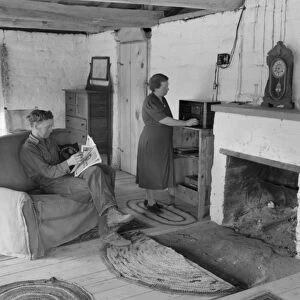 ADOBE HOUSE, 1940. A homesteader and his wife in their adobe house in Pie Town, New Mexico