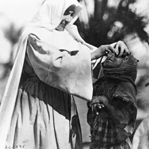 ALGERIA: BLINDNESS, c1920. A sister of the order of the White Nuns of the Sahara