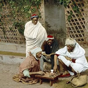 ALGIERS: CHESS GAME, c1899. Group of black Algerian men playing chess on a street in Algiers