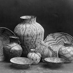 APACHE ARTIFACTS, c1907. Woven baskets and jars and a clay jug made by Apache Native Americans