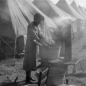 ARKANSAS: REFUGEES, 1937. A flood refugee washing clothes in the refugee camp at Forrest City