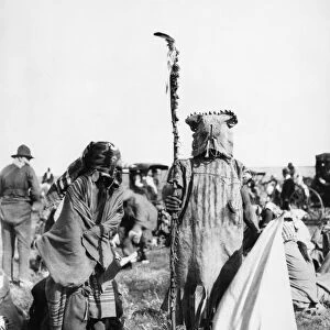 ASSINIBOIN DANCERS, 1906. Two Assiniboin boys wearing the costumes of a leader