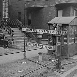 CHICAGO: VENDOR, 1941. A man with his newspaper stand and the sign reading A thing