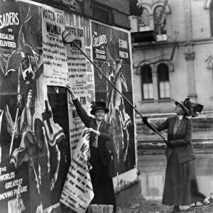 CINCINNATI: SUFFRAGETTES. Suffragettes Louise Hall and Susan Fitzgerald pasting signs for Votes For Women on a street in Cincinnati, Ohio, 1912
