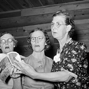 COMMUNITY SING, 1940. Three members of ladies quintette at a community sing at Pie Town