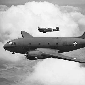 A Curtis Commando C-46 transport aircraft accompanied by a Curtis P-40F Warhawk fighter plane, 1942, during World War II