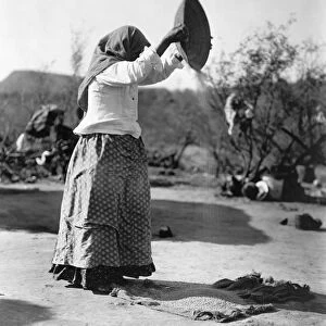 CURTIS: PAPAGO WOMAN, c1907. A Papago Native American woman winnowing wheat