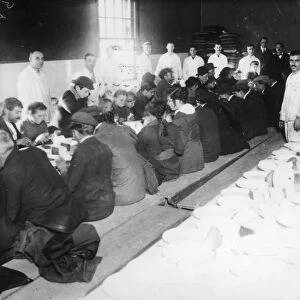 ELLIS ISLAND: DINNER, 1920s. Immigrants being served 25 cent dinners at Ellis Island