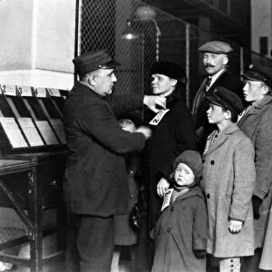 ELLIS ISLAND: TAGGING, 1905. An immigrant family at Ellis Island, New York City