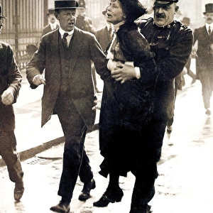 EMMELINE PANKHURST (1858-1928). English woman-suffrage advocate. Mrs. Pankhurst arrested outside Buckingham Palace, London, while trying to present a petition to King George V, 21 May 1914