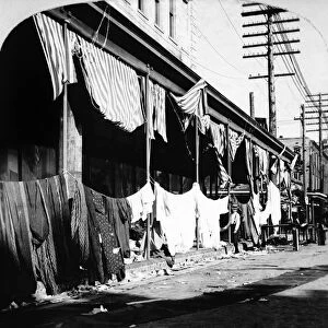 GALVESTON: FLOOD, 1900. Merchants drying goods after flooding from a hurricane in Galveston