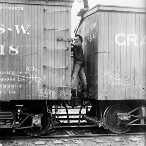 HOBOS, c1915. Hoboes fighting between railroad cars. Photograph, c1915