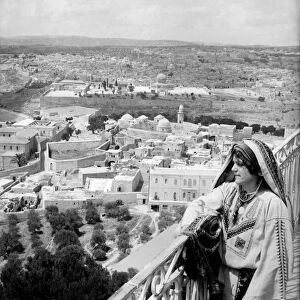 HOLY LAND. Woman on a balcony overlooking East Jerusalem from the Mount of Olives