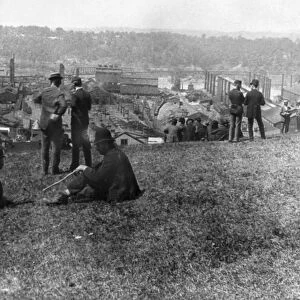 HOMESTEAD STRIKE, 1892. Carnegie steel workers on strike look over the steel mill