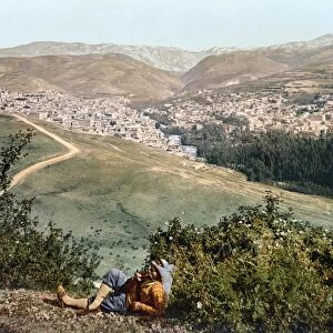 LEBANON: ZAHLE, c1895. A man lounging on a hill overlooking the city of Zahle, Lebanon