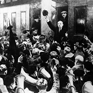 LENIN AT FINLAND STATION. The arrival of Russian Communist leader Vladimir Ilich Lenin (facing crowd with hat raised) at the Finland Station in Petrograd, April 1917. Joseph Stalin, who was not actually present at the event, is fictitiously depicted standing behind Lenin. Soviet painting, c1930s