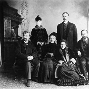 MARK TWAIN AND GEORGE WASHINGTON CABLE. Samuel Langhorne Clemens (left) and George Washington Cable (right) flanking the family of Erasmus Mason Moffett, Twains relatives by marriage: Widow Sarah M. Cox Moffett, daughters Lizzie (standing) and Ella, and son-in-law Valentine Surghnor, Lizzies husband. Photographed at Quincy, Illinois, 12 January 1885