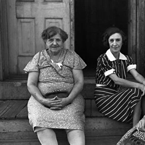 MINNESTOTA: WOMEN, 1939. Three women sitting on a stoop of a boarding house in St