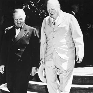 President Harry S. Truman of the United States and Prime Minister Winston Churchill of Great Britain descending the steps of the Presidents residence at Potsdam, Germany, July 1945