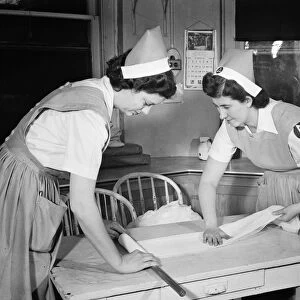 RED CROSS, c1940-43. Red Cross nurses aides preparing surgical bandages