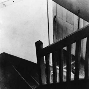 SHAKER STAIRCASE, 1930s. View from above of an interior stairwell in a building