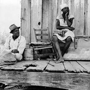 SHARECROPPER COUPLE, 1937. An African American sharecropper and his wife with no tools