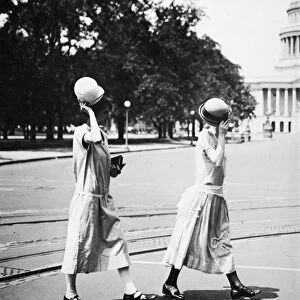 WOMENs FASHION, c1920. Two young campaigners for equal rights tipping their hats in Washington